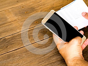 A man holding smart phone for using online banking app for paying credit card bill