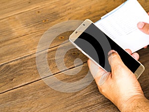 A man holding smart phone for using online banking app for paying credit card bill