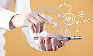 Man holding smartphone. API. Application Programming Interface. Software Development. Technology