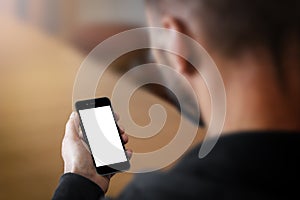 Man holding a smartphone with blank screen.