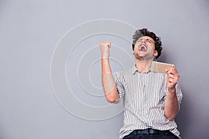 Man holding smartphone and celebrating his success