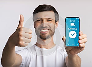 Man holding smartphone with delivery tracking website