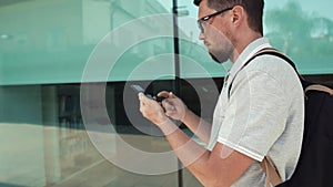 Man holding smartphone while walking.