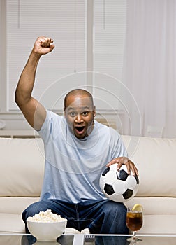 Man holding soccer ball cheering