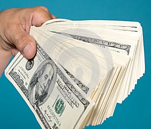 Man holding stack of dollar bills