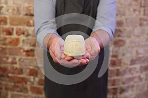 Man holding a steak and kidney suet pudding