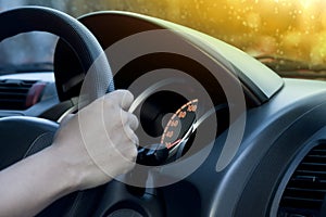 Man holding steering wheel of car.