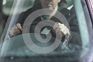 Man holding the steering wheel with two hands photo