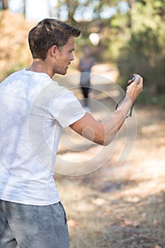 Man holding stopwatch on running trails