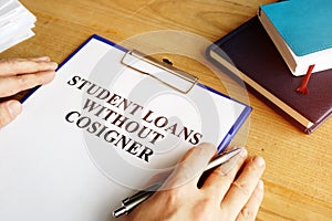 Man holding student loans without cosigner application form