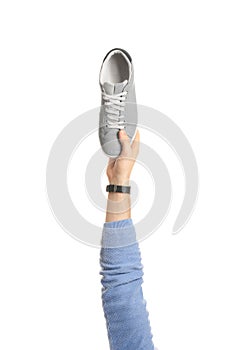 Man holding stylish shoe on white background,