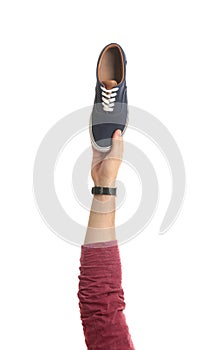 Man holding stylish shoe on white background,