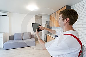 man holding tablet with app smart home on screen