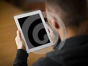 Man holding a tablet with blank screen.