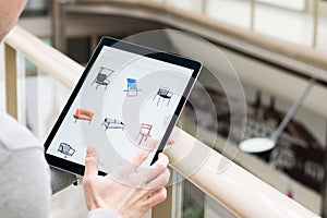 Man holding tablet buying furniture online