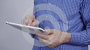 A man holding a tablet computer in his hand