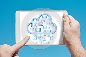 Man holding a tablet device and cloud computing communication icon to download stored data