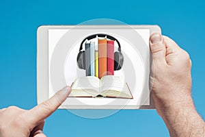 Man holding a tablet device showing audiobooks concept