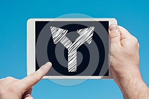 Man holding a tablet device showing two way arrow symbol concept