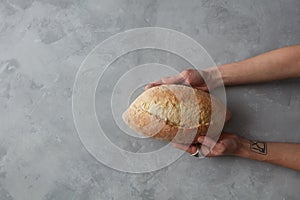 Man holding tasty fresh bread,