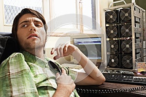 Man Holding Telephone Receiver At Computer Desk