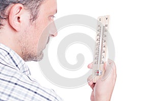 Man holding thermometer and checking temperature