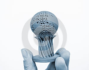 Man holding three-dimensional volumetric model printed on 3D printer for metal