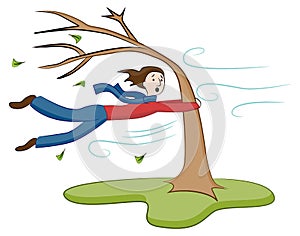 Man Holding On To Tree on Windy Day