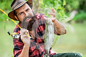 Man holding a trout fish. Fishing. Angler with fishing trophy. Fisherman and trout. Fishing backgrounds. Man hold big