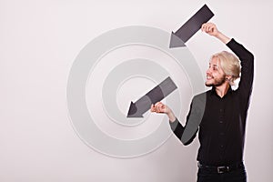 Man holding two arrows pointing same direction