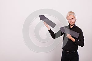 Man holding two arrows pointing same direction