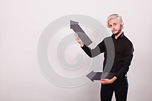 Man holding two arrows pointing same direction