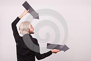 Man holding two arrows pointing same direction
