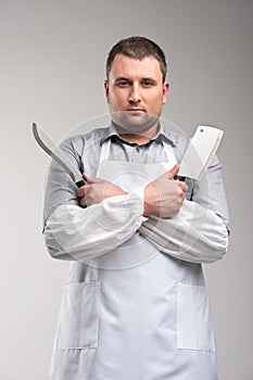 man holding two butcher knives