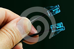 Man holding Two cables with blue rj-45 connector