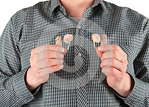 Man holding two hearing aids