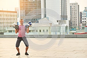 Man holding two hoverboards.