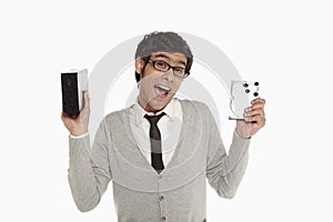 Man holding up an external hard disc
