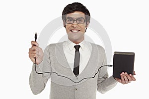 Man holding up an external hard disc