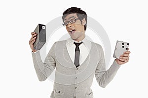 Man holding up an external hard disc