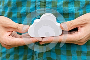 Man holding up a small white cloud object symbol in his hands, closeup. Cloud server computing, distributed processing power and