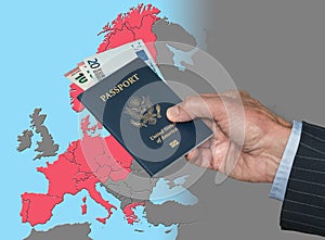 Man holding US passport and Euros on map of Schengen Zone