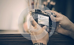 Man holding vintage camera taking a photo