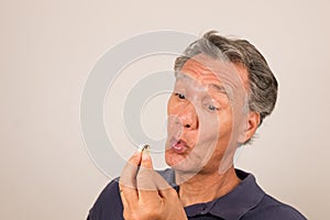 Man Holding Vitamins/Medication in his hand