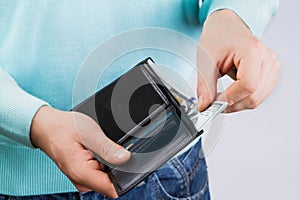 Man holding a wallet with money