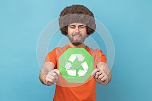 Man holding waste recycling symbol in his hand, worrying about ecology and environmental pollution.