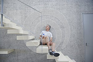 Man Holding Water Bottle On Steps