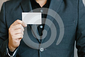 Man holding white business card