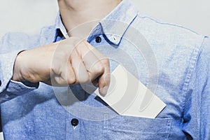 Man holding white business card on concrete wall background