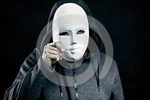 Man holding white mask